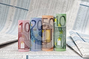 Euro bills on financial newspaper