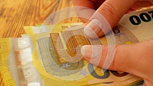 Euro bills. hands count euro bills. Expenditures and earnings of women in Europe.Money accumulations and savings.
