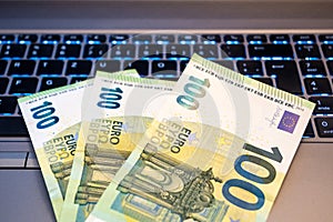 100 Euro Bills on Keyboard - Home Office Income Concept