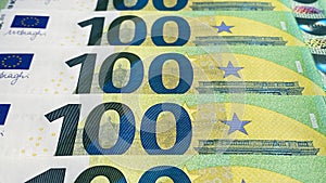 The 100 euro bills are stacked one on top of the other. Close-up. One hundred euros. The single currency of the European Union.