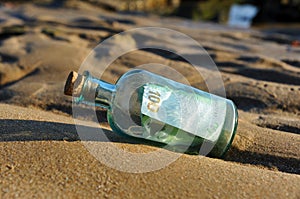 100 euro in a bottle on the sand