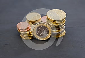 Euro cents on a black background. Stacks of coins on the table.