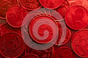 Euro cents coins close-up in red light. Euro currency inflation.Euro exchange rate in the European Union.Money