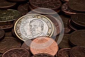 Euro coin with Juan Carlos I`s face amidst eurocent coins