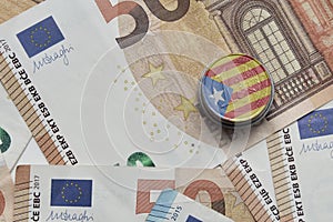euro coin with national colorful flag of catalonia on the euro money banknotes background