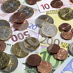 Euro Coins on 10, 20, 100, 200, and 500 Euro Bank Notes