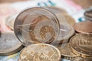 Euro coins and bank notes on wooden table background