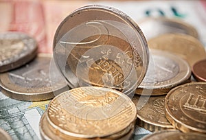 Euro coins and bank notes on wooden table background