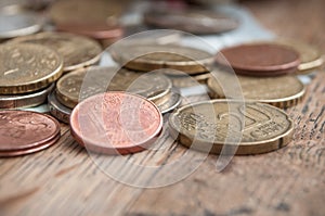 Euro coins and bank notes on wooden table background