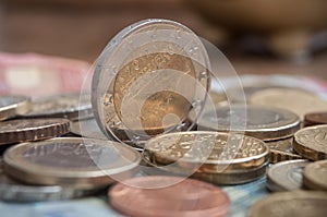 Euro coins and bank notes on wooden table background