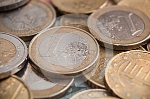 Euro coins and bank notes on wooden table background