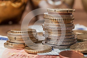 Euro coins and bank notes on wooden table background