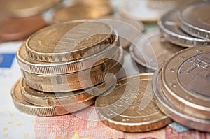 euro coins and bank notes on wooden table background