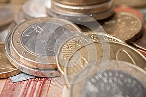 euro coins and bank notes on wooden table background