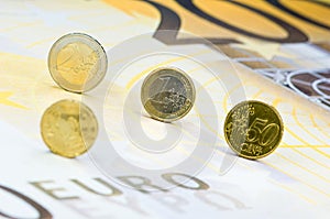 Euro coins on banknote