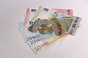 Euro coins and bills on a blank table