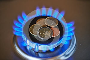 Euro coins on burning stove. Natural Gas Price concept photo