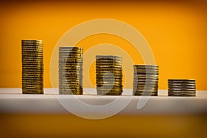 Euro coins and eurocents stacked on a yellow background. Euro mo