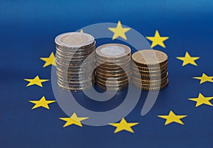 Euro coins, European Union, over flag