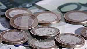 Euro coins falling down on euro banknotes