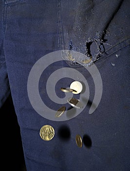 Euro coins falling from a hole in the pocke