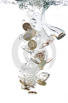 Euro coins falling into the water