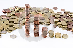 Euro coins forming different high cylinders