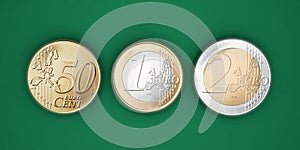 euro coins isolated on green background