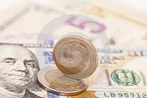 Euro coins over dollar notes
