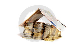 Euro Coins pile House with banknote roof