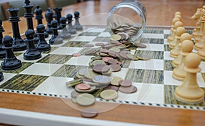 euro coins scattered on a chessboard