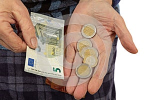 euro coins in senior hands