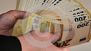 Euro currency banknotes pack.Fan of banknotes in hands on a light background.Two hundred euro pack in female hands