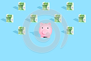 . Euro currency banknotes pattern and pink piggy bank on bright blue background. The concept of financial savings and different