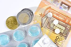 euro currency and medical tablets, cost of medical care concept