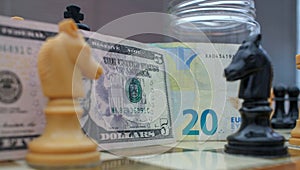 euro and dollar banknotes among chess knights
