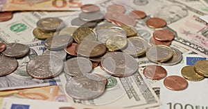Euro and Dollar coins on top of banknotes, EUR and USD bills