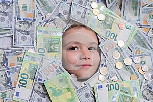 Euro and dollar concept. Funny kids face in money dollars banknotes background. Shopping and financial concept. Money