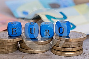 Euro letter cubes on coins concept
