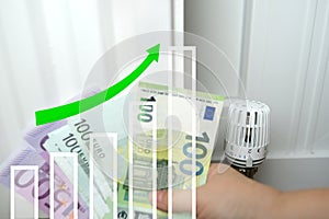 euro money 100, 500 bills in female hand, valve on heating battery, growth graph and up arrow, growth in direction development,