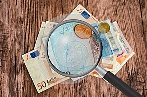 Euro money background with magnifying glass