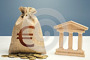 Euro money bag and bank / government building. Budgeting, national financial system. Lending loans, placing deposits. Monetary