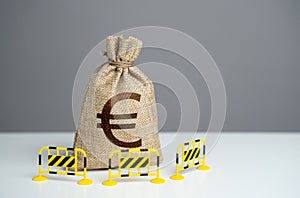 Euro money bag is fenced with barriers. Capital restrictions.