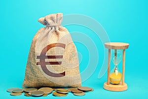 Euro money bag and hourglass. Profitability and return on investment. Time for paying taxes. Pension savings. Customer loyalty
