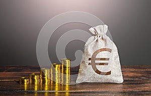 Euro money bag and increasing stacks of coins. Savings and accumulation. Rise in profits, budget fees. Investments. Raise incomes