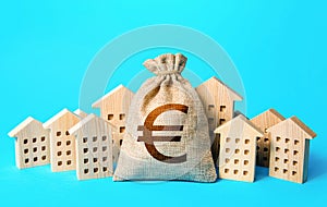 Euro money bag and residential buildings. Municipal budgeting. Rich city. Rental business. Realtor services. Sale of real estate.