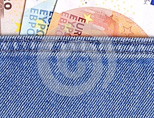 Euro money banknotes in blue jeans pocket.