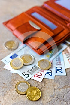 Euro money - banknotes and coins - in brown wallet