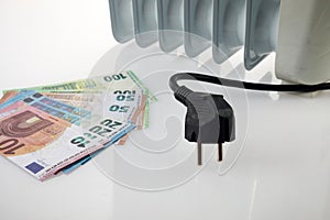 Euro money banknotes on heating radiator battery. Concept of expensive heating costs and rising energy bill