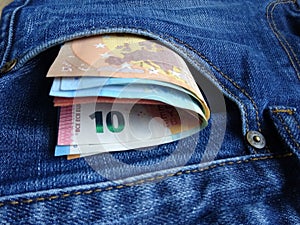 Euro money banknotes in jeans pocket